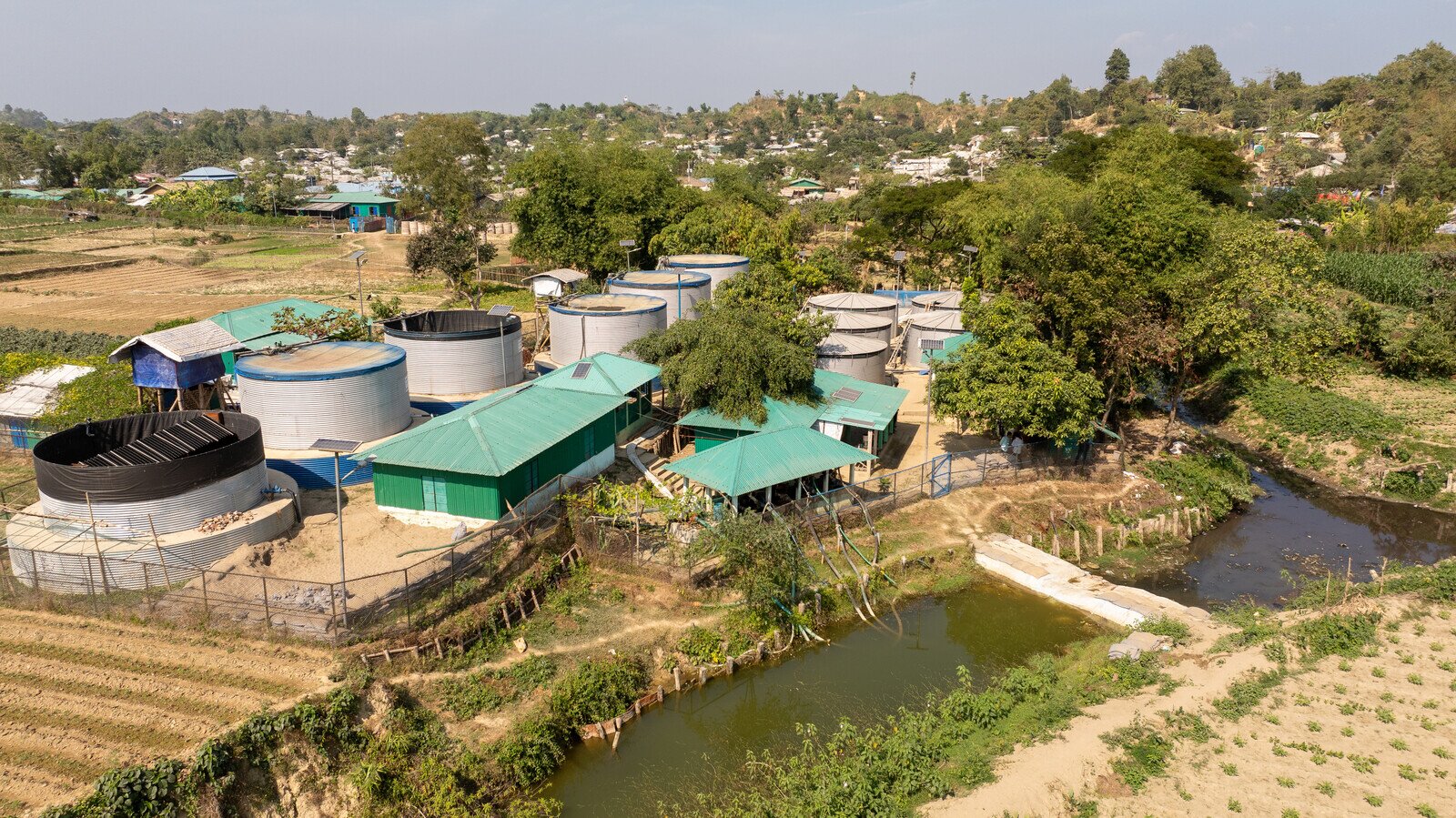 Aerial view of the Surface Water Treatment Plant linked to the nearby unclean water body in Teknaf with the Rohingya Camps in the back. (Mushfiqul Alam/Oxfam)