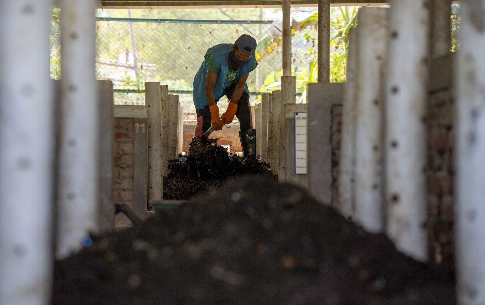 A community worker works inside the Solid Waste Management Facility in Refugee Camp - 4, Ukhiya, to separate the solid waste chunks. (Mushfiqul Alam/Oxfam)