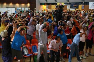 Over 300 walkers attended the Oxfam Trailwalker 2013 Briefing and they were practicing warm-up exercise.