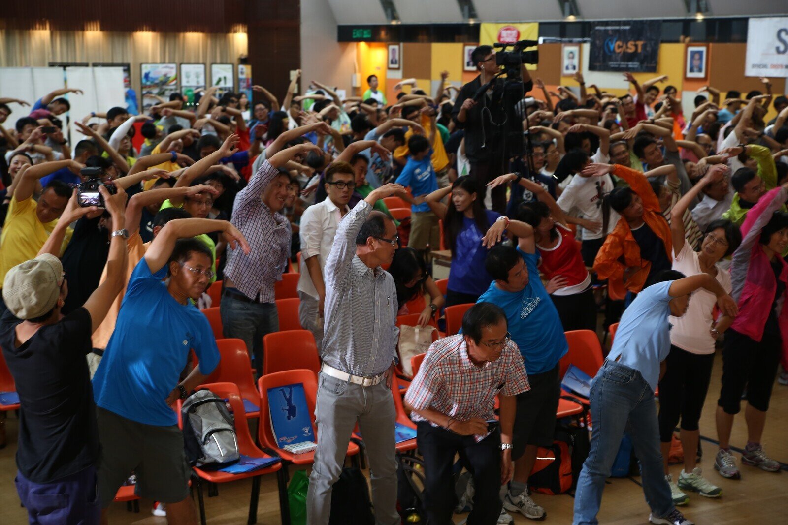 Over 300 walkers attended the Oxfam Trailwalker 2013 Briefing and they were practicing warm-up exercise.