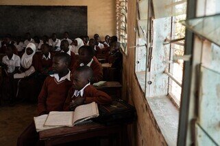 A new but small campus was built, but it still lacked school facilities and textbooks. Students still had to share their chairs and desks.