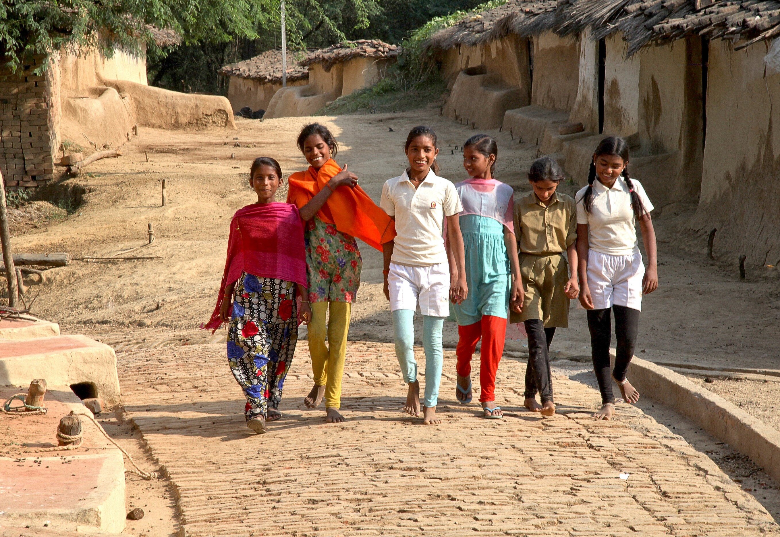 After undergoing training, Komal (right) and other girls in her village not only grew stronger and more confident, but were also more motivated to go to school.