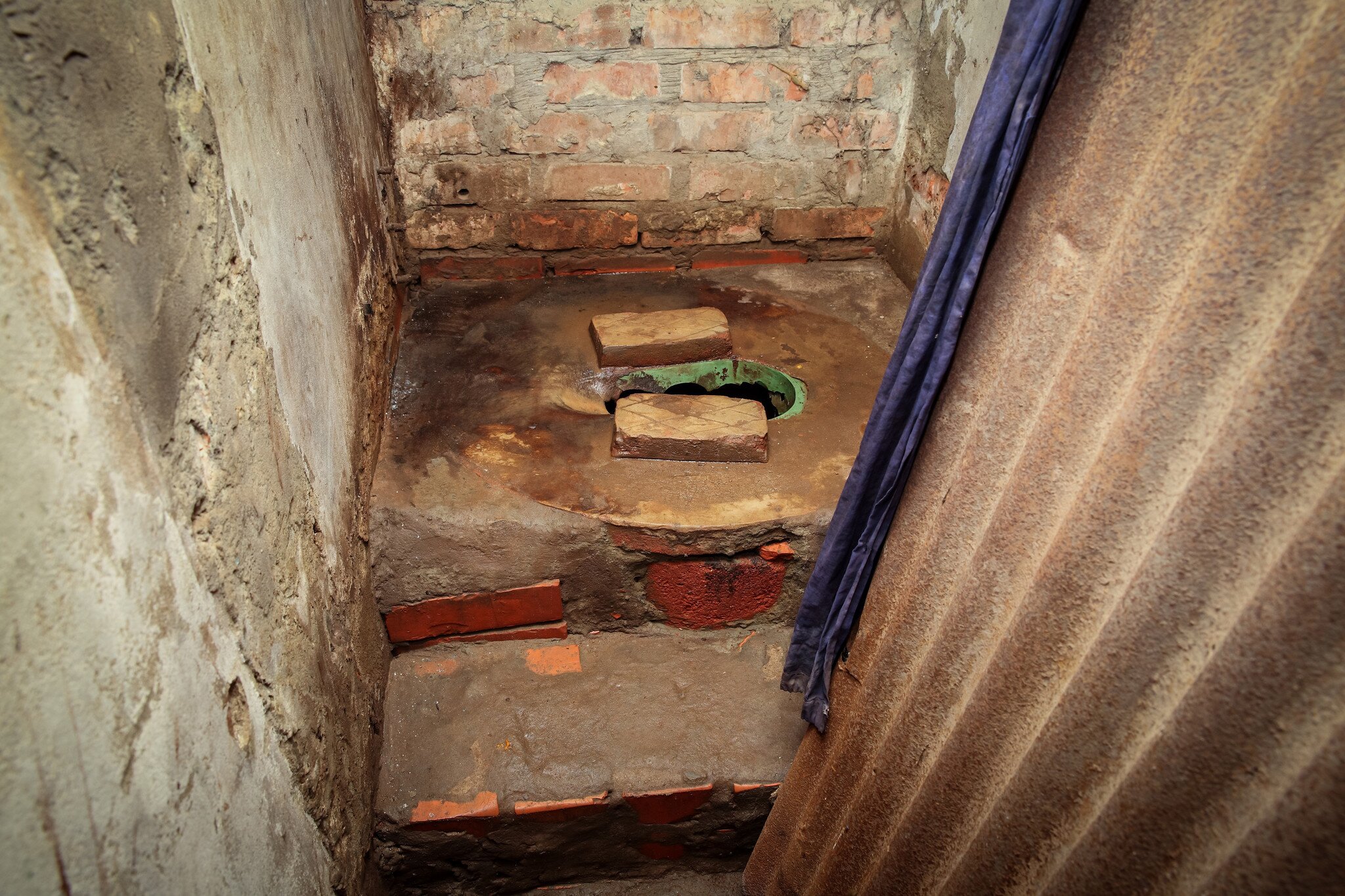 A rundown squat toilet.